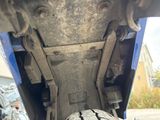 a close up of a tire that is underneath a vehicle