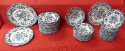many plates that are sitting on a red cloth