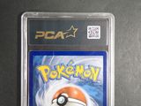 the pokemon card is in a plastic holder on a table
