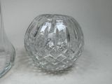 two glass vases sitting next to each other on a table