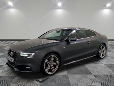 the audi s5 sedan is parked on a checkered floor in a garage