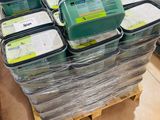 many containers of food sitting on a pallet in a store