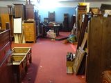 a room filled with lots of old furniture and a red carpet