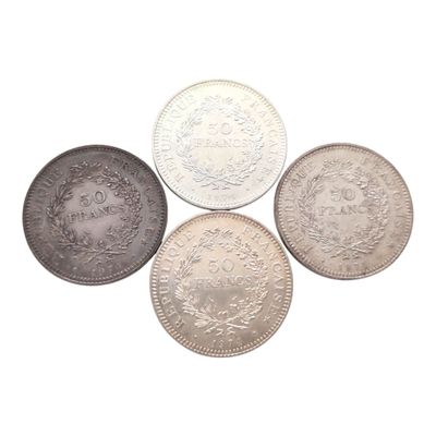 quatre types différents de pièces d'argent sur fond blanc