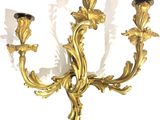 a gold candle holder with three candles on it