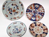 three plates with different designs on them sitting on a white surface