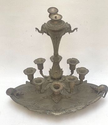 a silver candle holder with five candles on it
