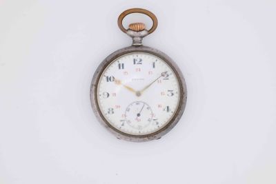 a close up of an old pocket watch on a white surface