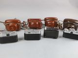 six cameras are lined up in a row on a white surface