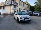 a car parked in front of a building in a parking lot