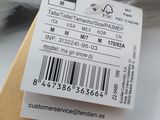 a tag attached to a watch that is on top of a box