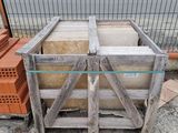 a wooden crate that has a lot of bricks in it