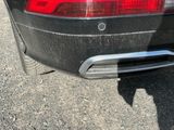 a black car parked on the side of the road