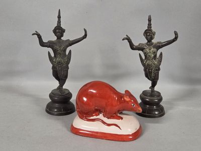 three figurines of a rat and a statue of a woman