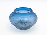 a blue vase that is sitting on a white surface