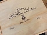 a wooden box with a bottle of wine in it