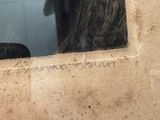 a reflection of a person in a mirror in a bathroom