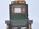 a small toy truck with a barrel on the back of it