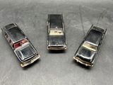 three old model cars that are sitting on a table