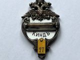an image of a small metal badge with the name of a city