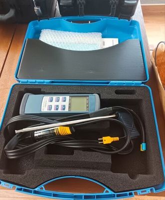 a blue case with a digital thermometer in it on a wooden table