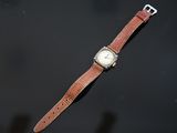 a watch that is sitting on a black surface