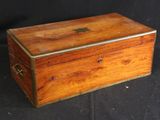 an old wooden box sitting on top of a black table