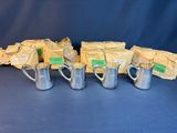 six silver mugs with labels on them are lined up against a blue background