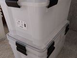 two large plastic boxes stacked on top of each other