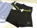 two men ' s boxer shorts with a striped shirt on a table