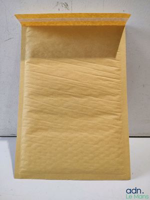 a close up of a bag of yellow mail sitting on top of a table