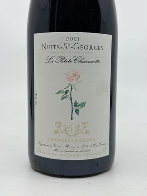 a bottle of wine that has a rose on it