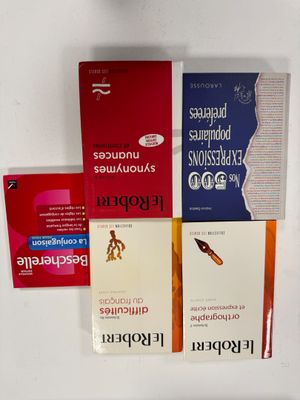 four books that are sitting on top of a table
