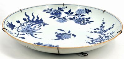 a large blue and white bowl with flowers and birds on it