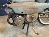 an old motorcycle that is sitting in a garage