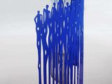 a blue sculpture of a group of people standing in a circle