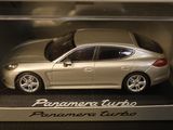 a silver toy car in a box on a table