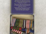 a small tin with a bunch of ribbons in it