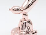 a pink balloon shaped like a rabbit sitting on top of a bowl