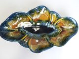 a close up of a blue and green bowl on a white surface