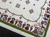 a white table cloth with a picture of a group of people on it