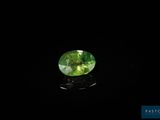 a green tourmaline gems on a black surface