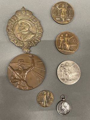 five medals on display on a table next to each other