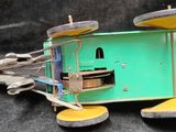 a green toy truck with a bunch of tools inside of it