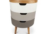 a white and grey chest of drawers with wooden legs