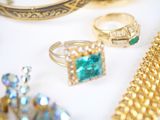 many different rings and bracelets that are on a table
