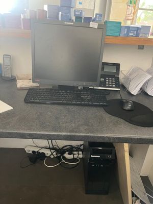 a desk with a computer and a phone on it