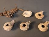 several pieces of pottery sitting on top of a table next to a piece of wood
