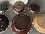 many different types of plates and bowls on the table