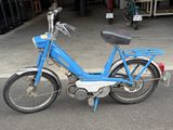 a blue bike that is parked in front of a garage